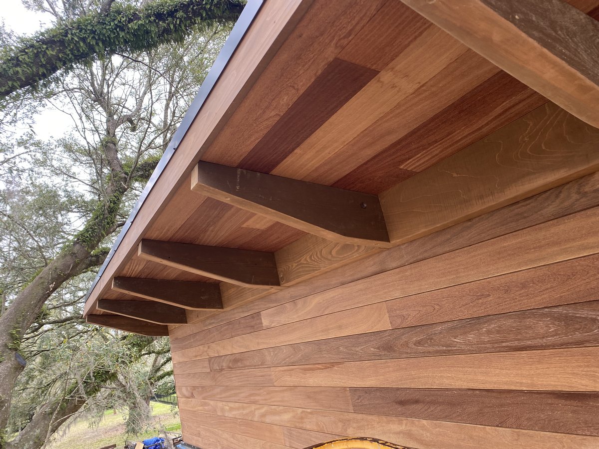 Cedar siding with exposed rafter tails — eave detail