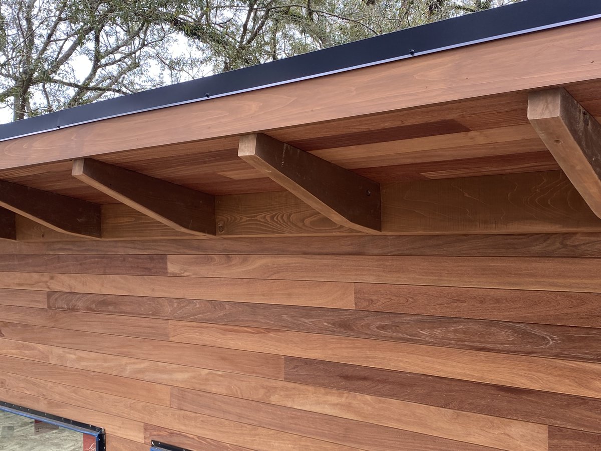 Hardwood siding and corbel detail — close-up