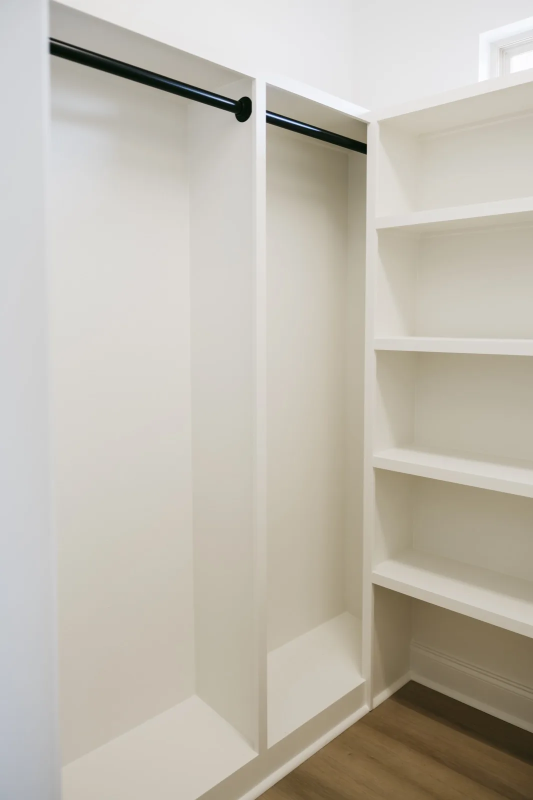 Walk-in closet with custom built-in shelving and clothing rod