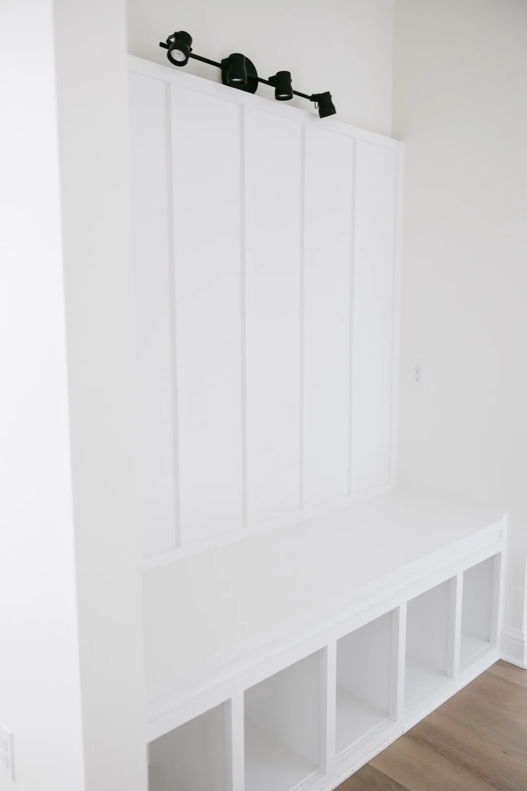 Mudroom wider angle showing full built-in bench and board-and-batten paneling