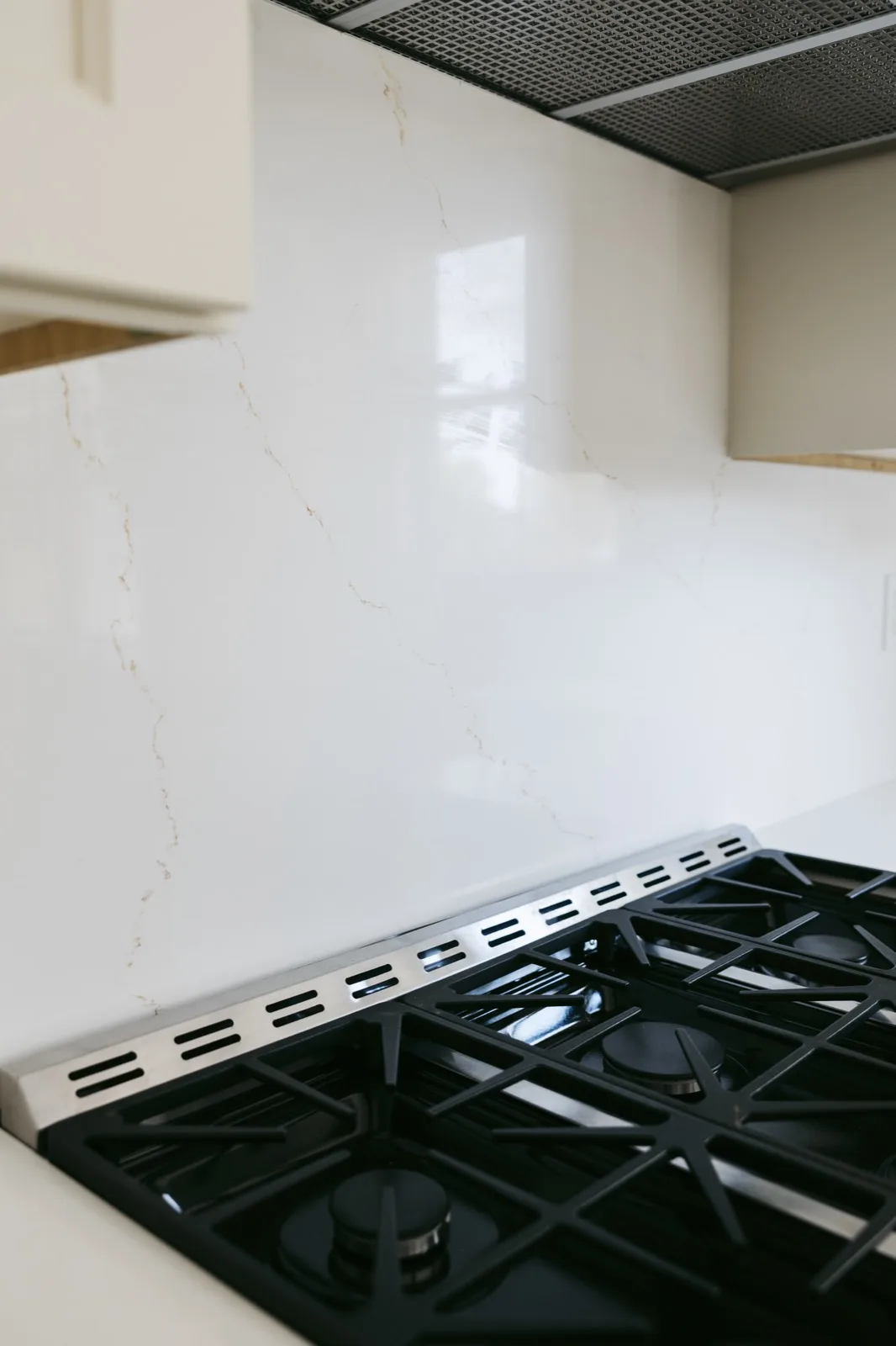 Second vanity area — brass industrial sconce bar, widespread faucet, white quartz top