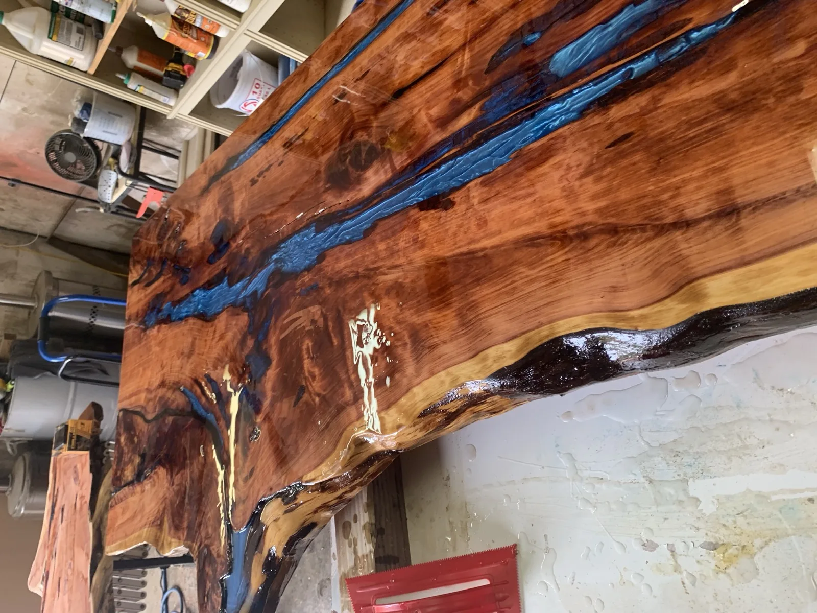 Deep blue epoxy river in red cedar slab — dramatic color contrast