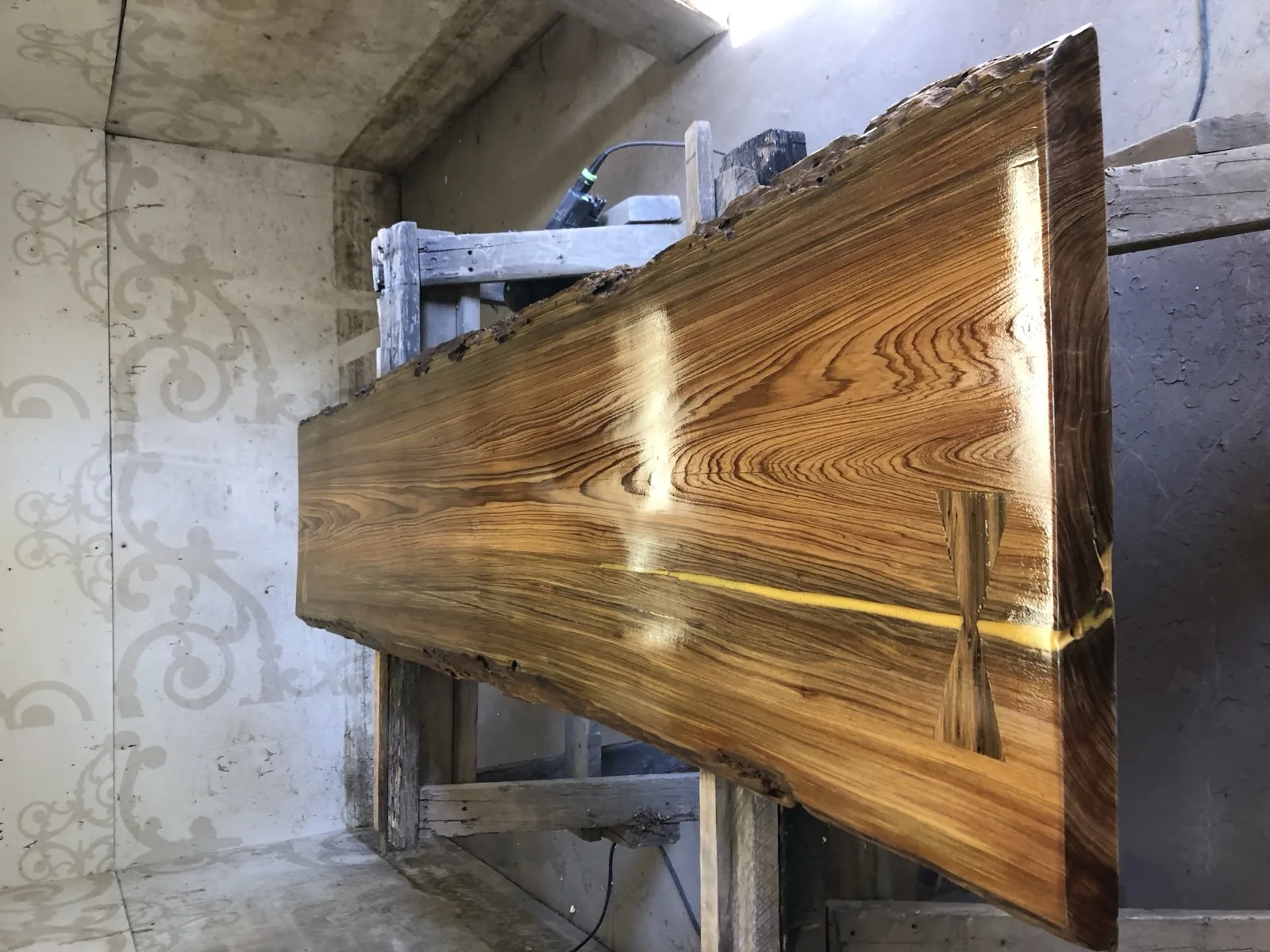 Full cypress slab with gold epoxy river — workshop side view showing scale and grain